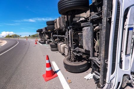 Semi truck laying on its side