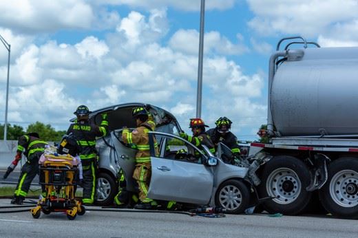 firemen rescuing injured person from truck accident