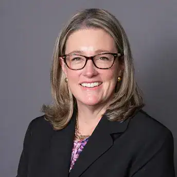 Palamisano & Goodman attorney headshot of female lawyer wearing glasses and blazer in a professional.