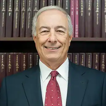 Robert G. Goodman attorney headshot in front of law books, Palmisano & Goodman, P.A., Woodbridge NJ,.