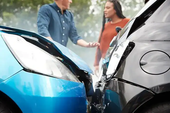 Attorney in Woodbridge firm scene after car crash with blue and black vehicles and concerned clients.